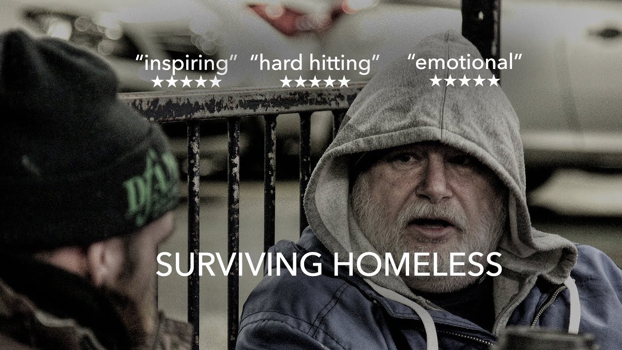 A man in a grey hood sits by railings with a coffee in Surviving Homeless