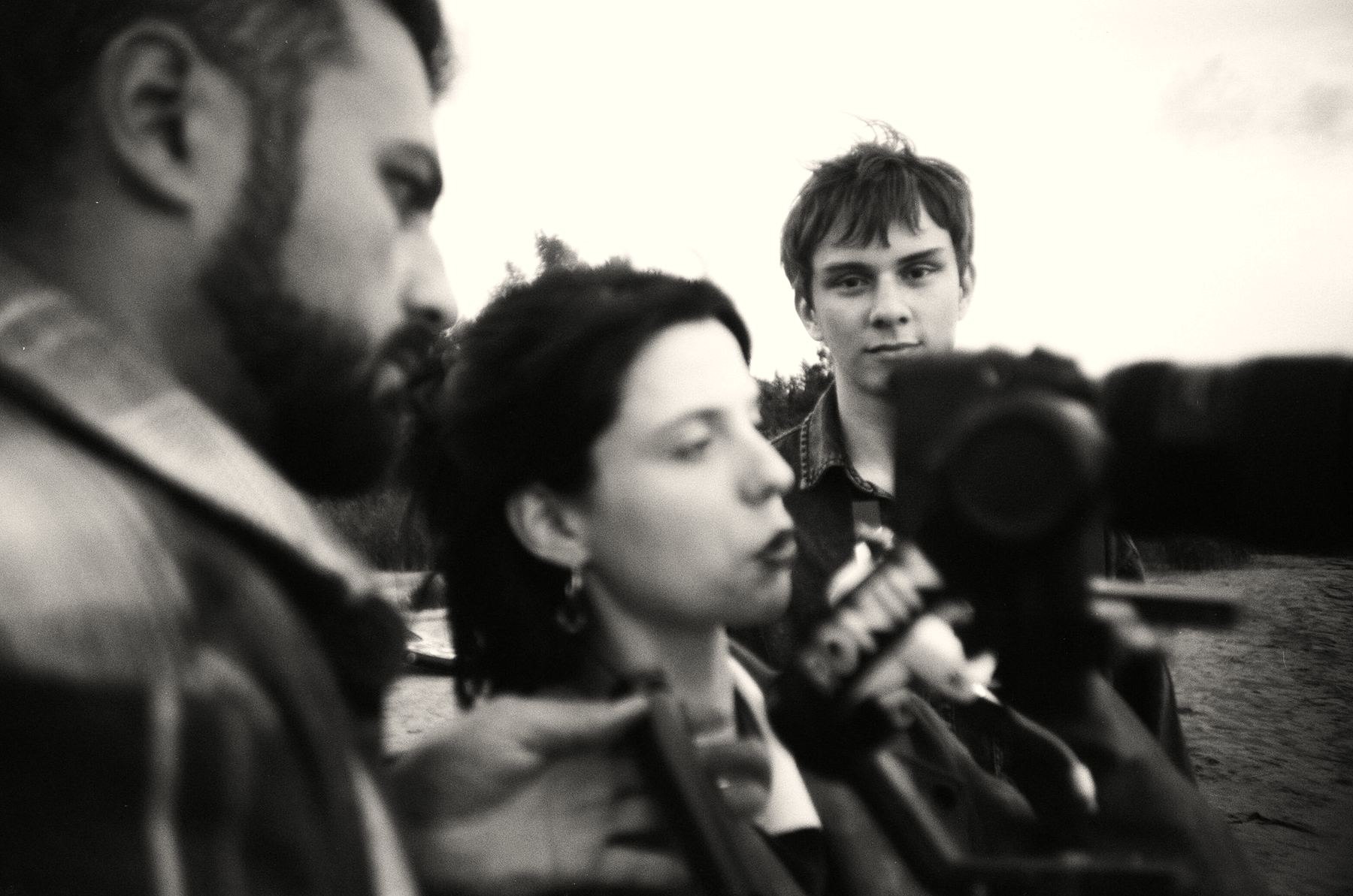 A film crew filming outdoors in black and white