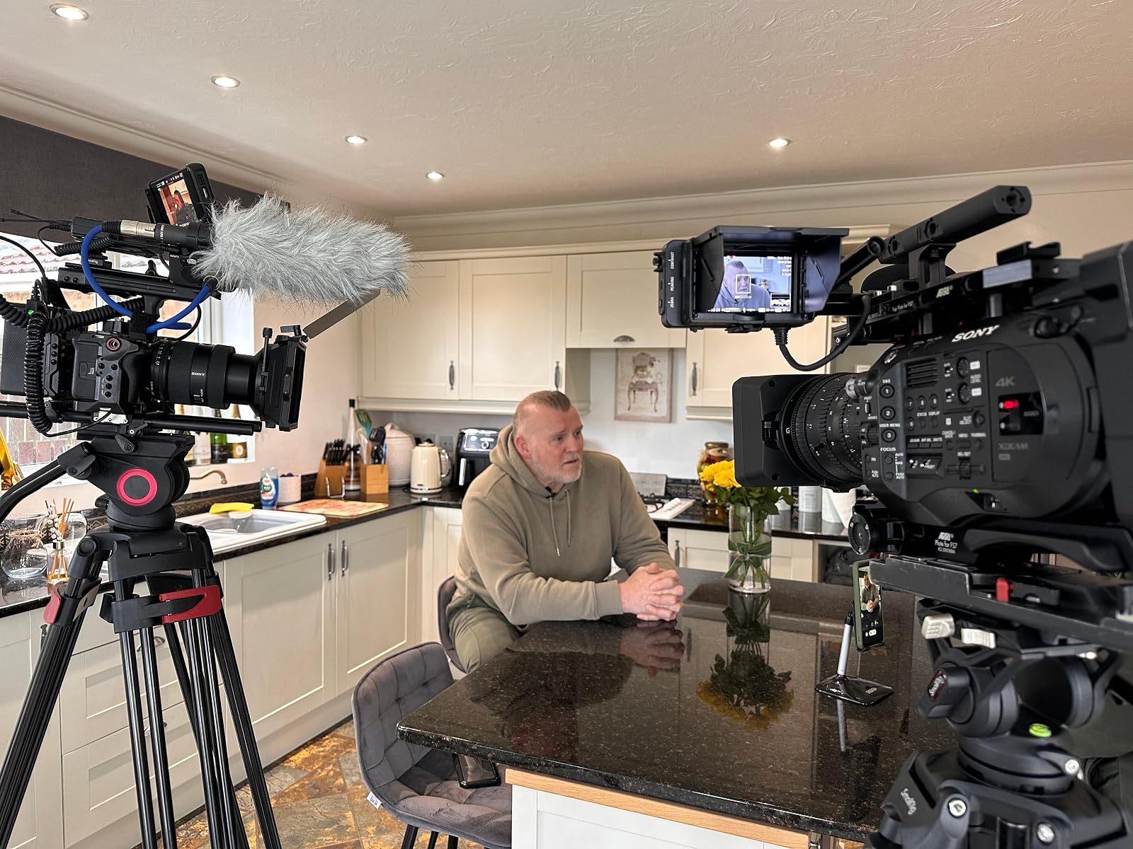 Two cinema cameras set up for an interview in a kitchen